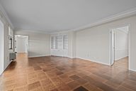 A room with a brown tiled floor and white walls.