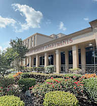 a picture of the front of the building with a garden in front of it