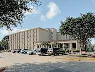 a large building with a parking lot in front of it
