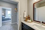 A bathroom with a white sink and a mirror.