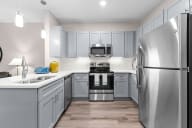 Active Adult  kitchen with stainless steel appliances and gray cabinets