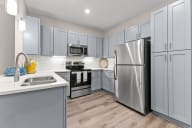 Active Adult  kitchen with stainless steel appliances and white cabinets