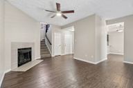 A spacious living room with a fireplace and hardwood floors.