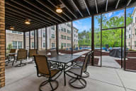 Active Adult apartments offer a patio with tables and chairs and a pickleball courts