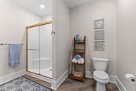 Active Adult bathroom with a shower and a toilet