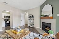 A living room with a fireplace and a coffee table.