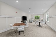 Active Adult conference room with tables and chairs and a television