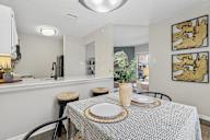 A dining room with a table set for two.