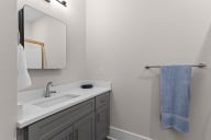 Active Adult  bathroom with a sink and a mirror and a towel rack