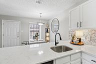 A kitchen with a white countertop and a sink.