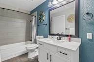 A white bathroom with a white toilet and a white sink.