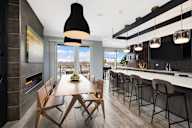 A modern kitchen with a dining table and chairs.