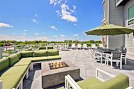 A patio with a fire pit and seating area.