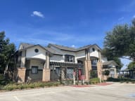 a house with a parking lot in front of it