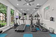 A gym with treadmills and exercise bikes.