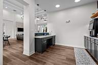 A kitchen area with a counter and cabinets.