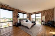 A bedroom with a large bed and a view of the city.
