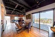 A modern dining room with a view of the city.