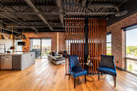 A room with a wooden floor and a brick wall.