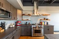 A modern kitchen with a stove top oven and a microwave.