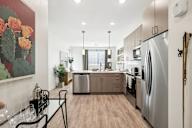 A modern kitchen with a refrigerator on the right.