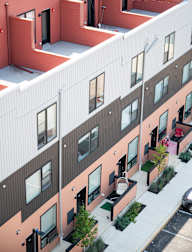 a view of the side of a building with windows and a courtyard