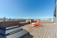 A wooden deck with two chairs and a table.