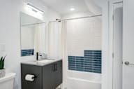 a bathroom with a sink and a shower and a mirror