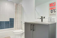 a bathroom with a sink and a toilet and a shower