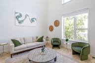 a living room with a couch and chairs and a coffee table