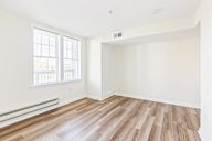 A room with wooden flooring and a window.