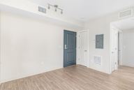 A room with a blue door and white walls.