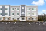 A large building with a parking lot in front of it.