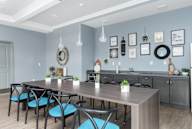 A modern kitchen with a dining table and chairs.
