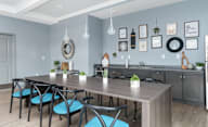 A modern kitchen with a dining table and chairs.