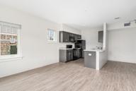 A kitchen area with a refrigerator, microwave, and oven.