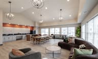 A modern living room with a kitchen in the background at Hudson Heights Apartments, Mechanicville, NY
