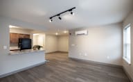 A spacious living room with a television and a window at Hudson Heights Apartments, Mechanicville, NY