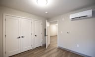 A room with a row of white cupboards and a white wall at Hudson Heights Apartments, Mechanicville, NY