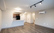 A kitchen area with a counter and cabinets is visible through a window at Hudson Heights Apartments, Mechanicville, NY