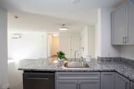 A kitchen with a granite countertop and a sink.