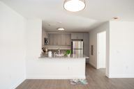 A kitchen with a white counter and a white ceiling.