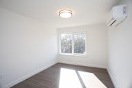 A room with a window and a ceiling light.