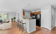 A kitchen with a bar stool and a countertop.