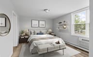 A bedroom with a large bed and a window.