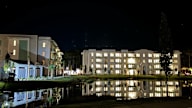 the building in which the hotel is located is lit up at night at Saltaire Apartment Homes in Santa Rosa Beach, FL 