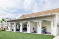Indoor/outdoor gym with sliding garage doors at Saltaire Apartment Homes in Santa Rosa Beach, FL