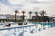 Resort style pool and chairs at Saltaire Apartment Homes in Santa Rosa Beach, FL