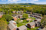 A bird's eye view of a residential area with houses and a playground.