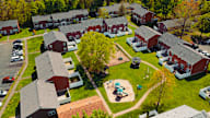 A bird's eye view of a small town with a playground in the middle.